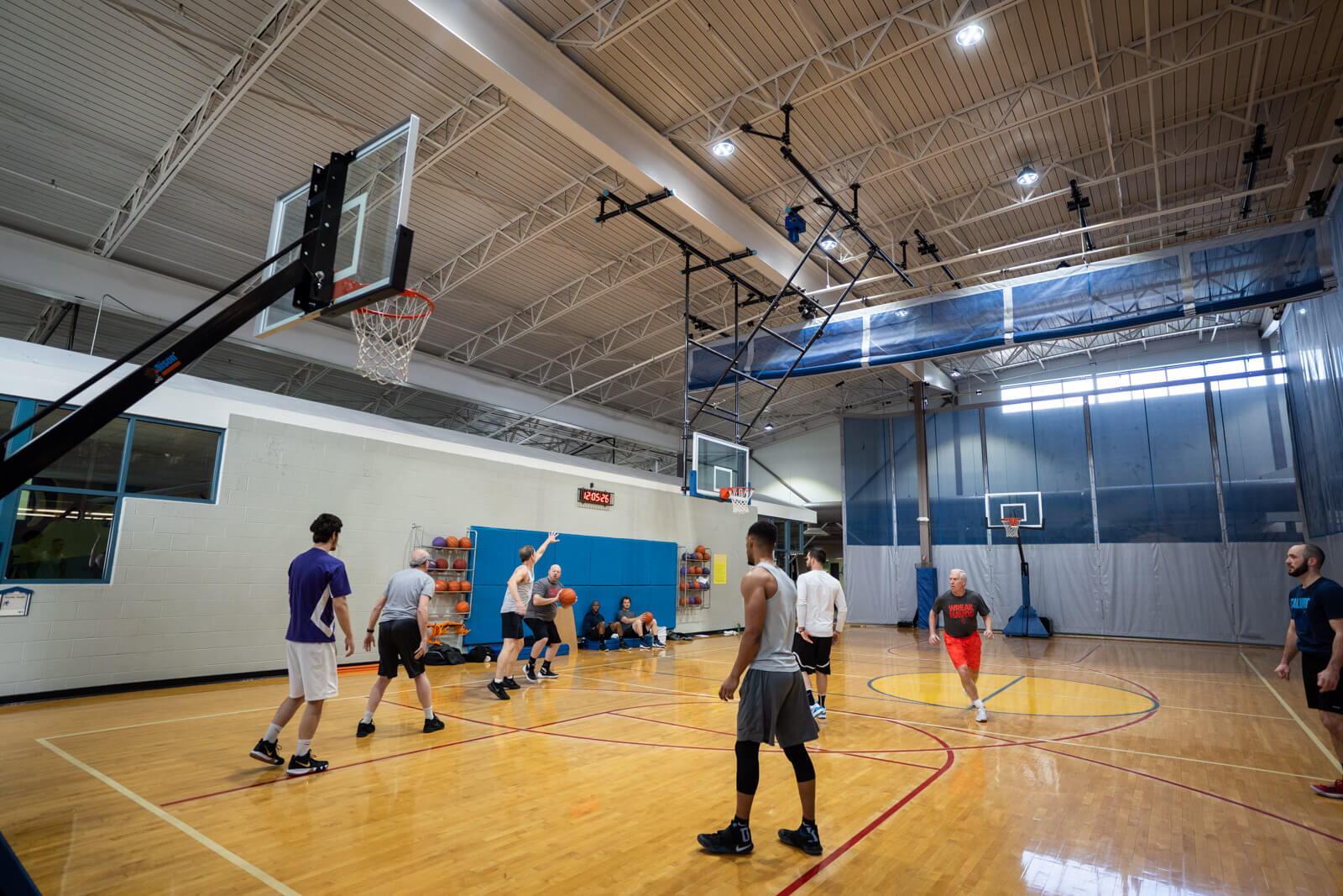 Men playing basketball on an indoor court