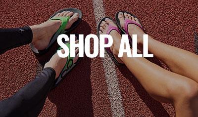 Recovery sandals on feet which are on a track.