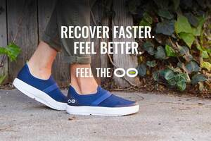 Person wearing OOFOS flip-flops outdoors