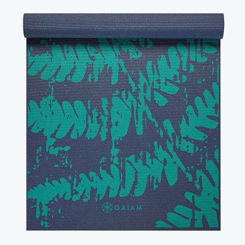 Rolled yoga mat with teal leaf pattern