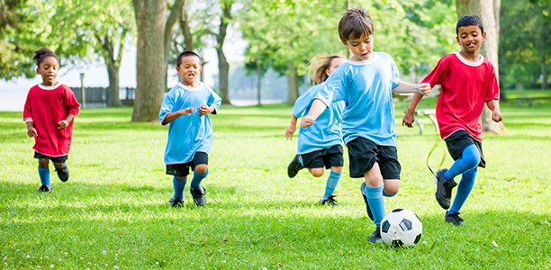 Children playing soccer on a field